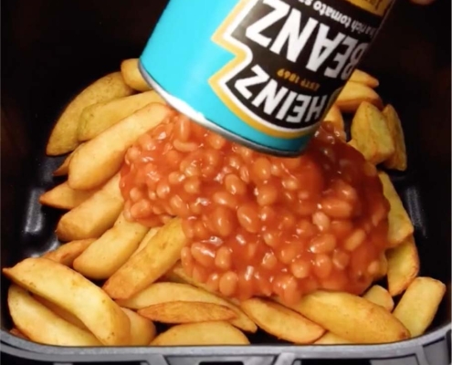 Cover the cooked chips with a standard size can of baked beans